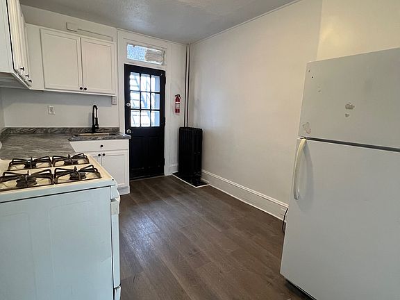 Kitchen looking towards entry door for unit