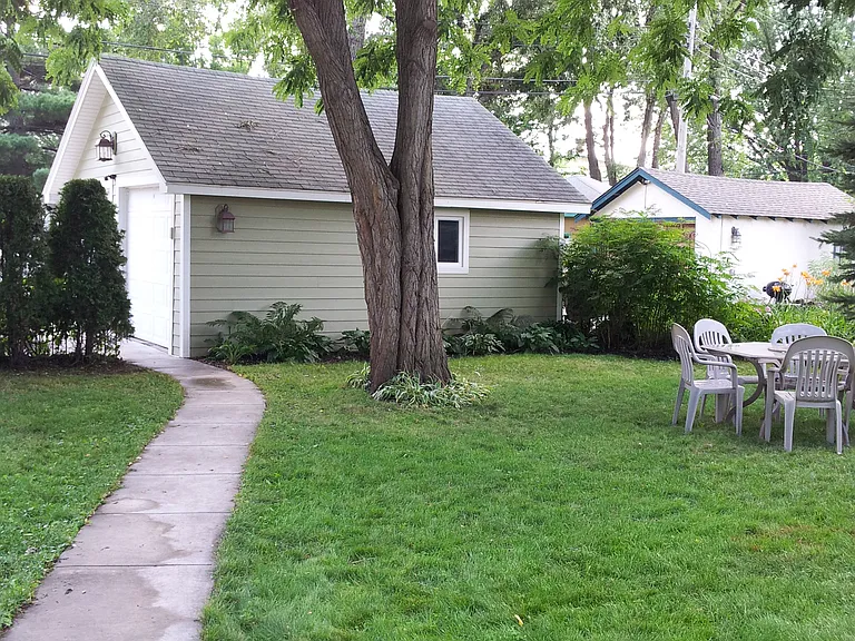 Back yard looking south. This tree has been replaced with a newer tree. The table and chairs are shared space for tenants and their guests. No fire pit allowed.