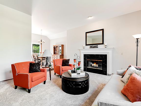 Formal living room with wood-burning fireplace.