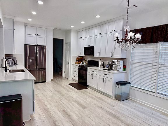 Newly renovated kitchen with new refrigerator, dishwasher, cabinets, counters and flooring.