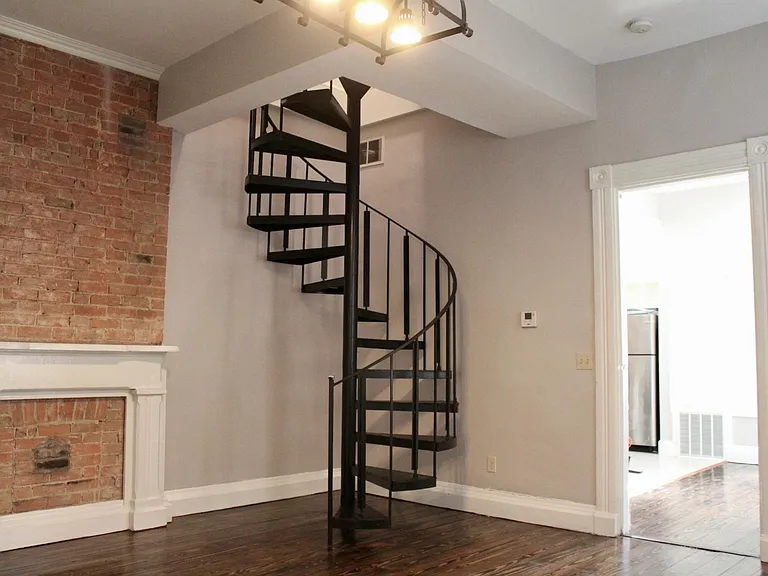 Spiral staircase from living room to second floor.