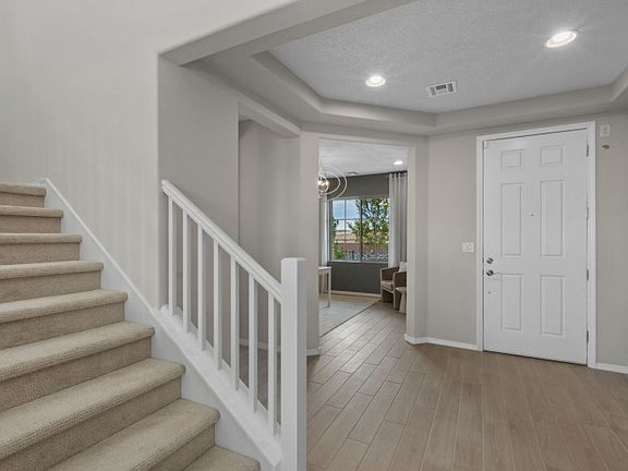 The first floor of the Trento includes a spacious entry with a tray ceiling plus a stair set to the