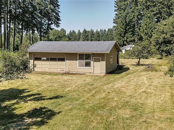 Approximately 865 Square Foot shop/garage. Half is mostly finished out, 2nd half is additional garage space. additional parcel behind shop. 