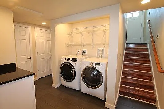 Laundry area with staircase down from front door. Closet and hall to downstairs bathroom #2.
