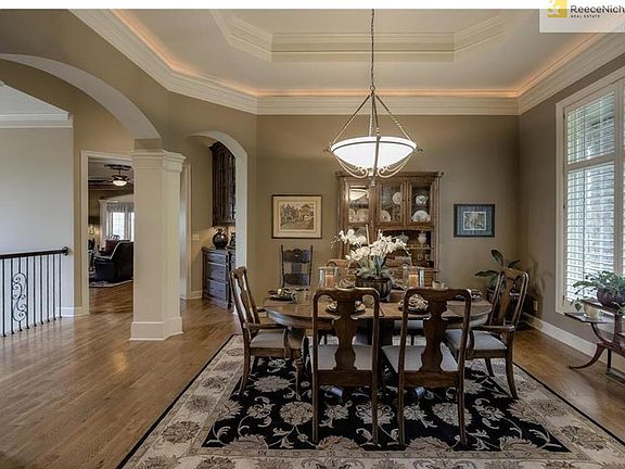 Large dining room with tons of natural lighting & stunning views of the front yard and oversize picture window of the backyard