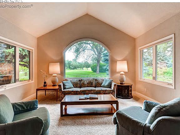 Living Room w/ Large Windows & Golf Course Views