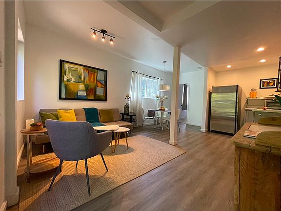 Open living, dining and kitchen area, (no stove/oven range), with lots of natural light!