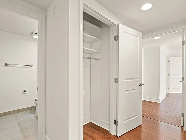 Bedroom with Closet, Bathroom, and Hardwood Flooring