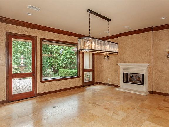 This room has been used as a formal living room, and as a formal dining room. The view of the fountain is stunning.