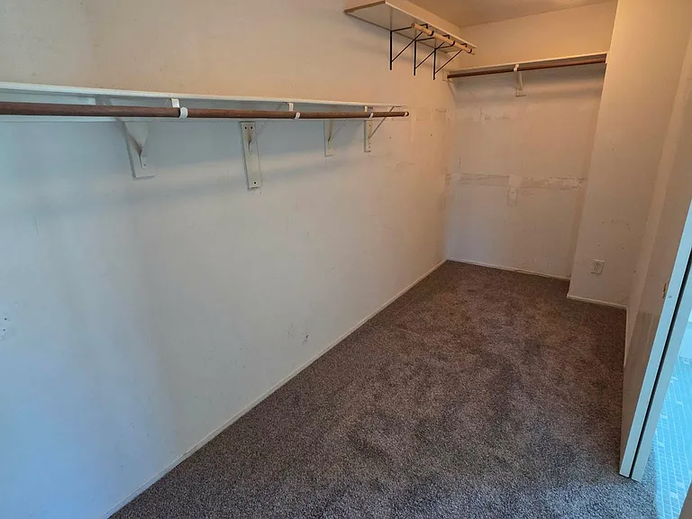 Oversized walk-in closet offering abundant storage and hanging space.