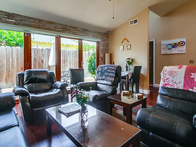 Living room with glass panels closed gives a great view of the outside. Also streams in lots of natural light.