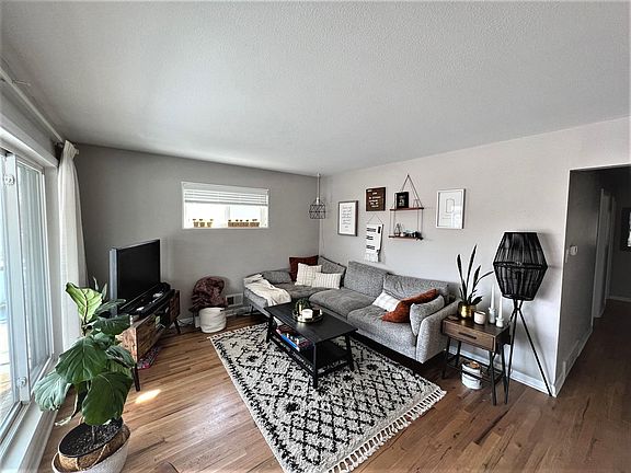 Newly refinished hardwood floors and fresh paint in living room - lots of light from large front window!