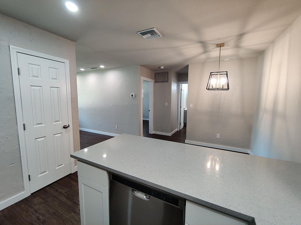 Kitchen view of dishwasher, pantry, dining area