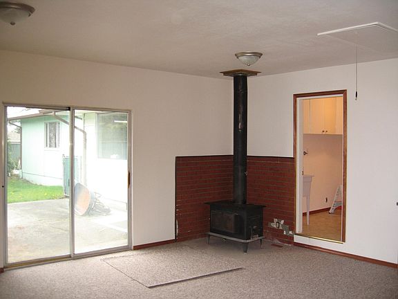 rec room, looking out onto back patio fenced in small yard