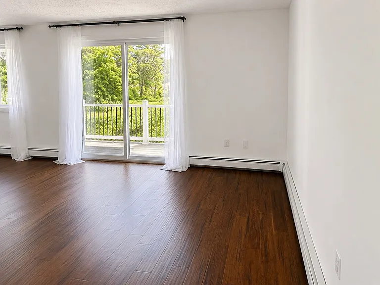 Open concept dining and living area with attached deck