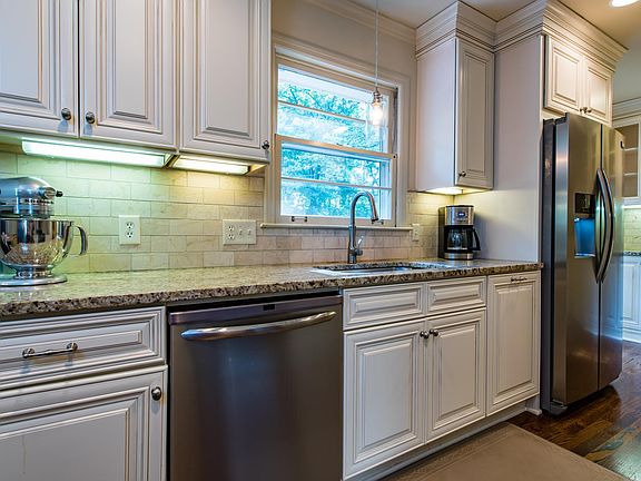 Closer shot of most used part of the kitchen with window looking over back deck