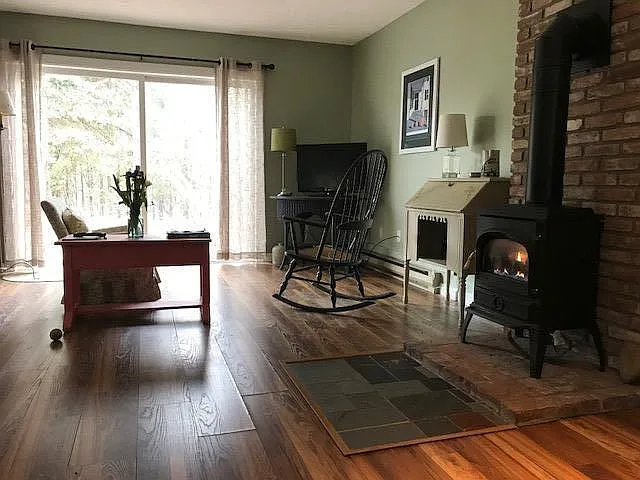Living area with large sliding glass door out to deck area