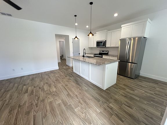 Living room (left) hallway (center) kitchen (right)