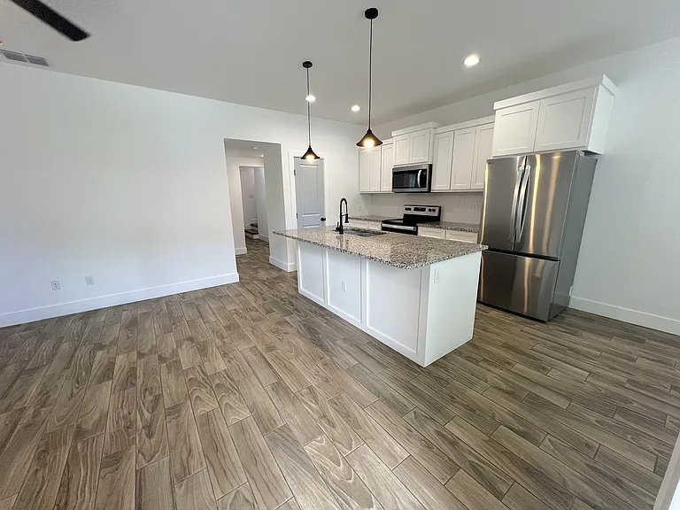 Living room (left) hallway (center) kitchen (right)
