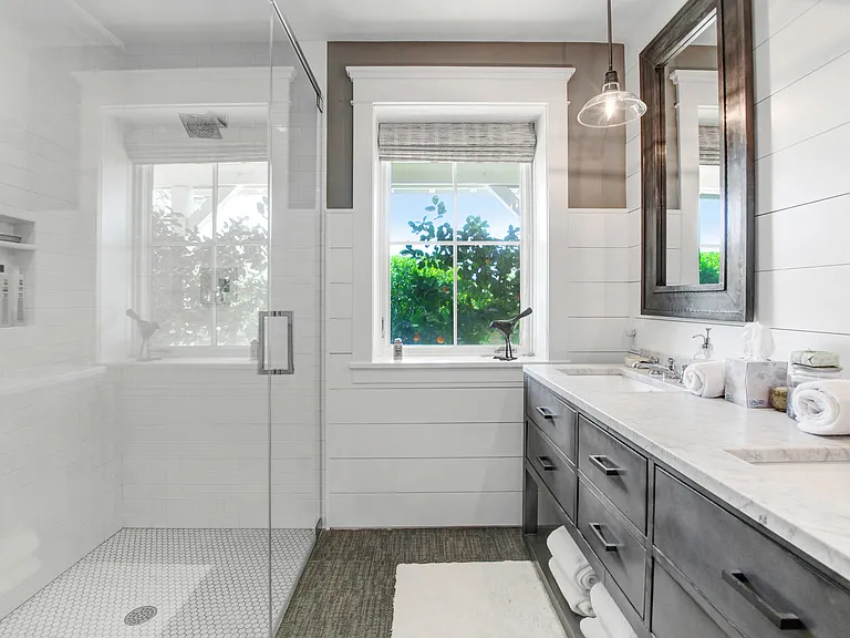 Downstairs Bath with Double Vanity and large Shower. View to exterior and pool