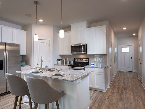 The kitchen island overlooks the dining and living areas.