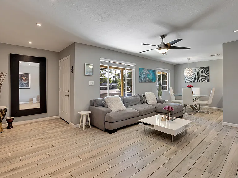 Open, light filled living room with modern porcelain tile flooring