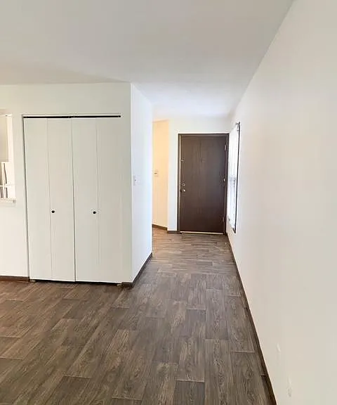 View of front door from family room. Kitchen is on the left.