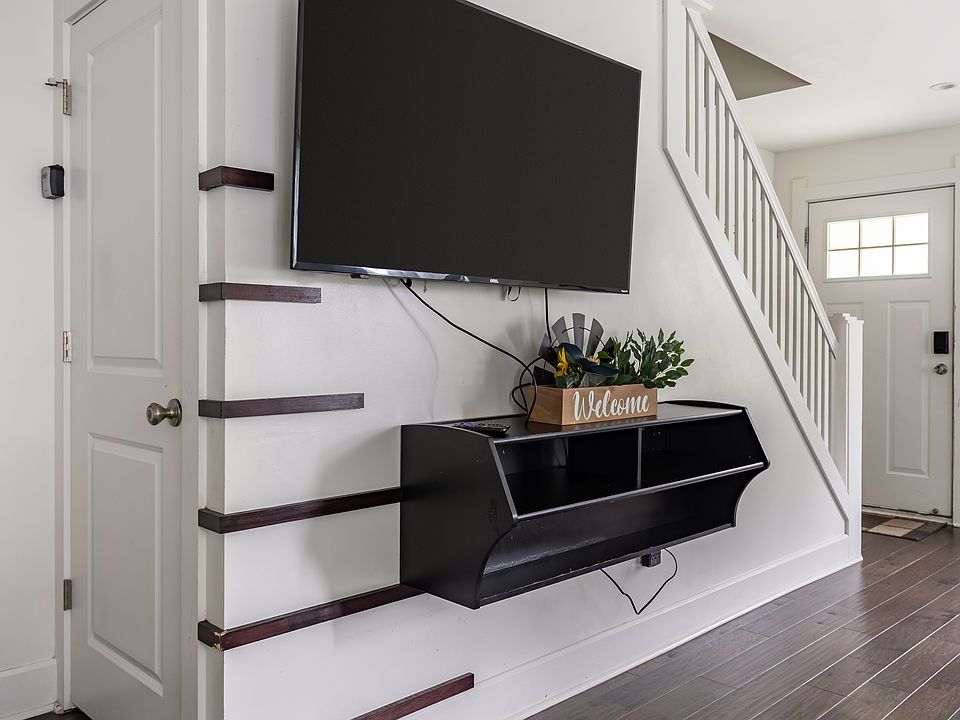 Whether it's sports, streaming, or family films, this TV has you covered __and hidden under the stairs is a clever storage space to keep your luggage and belongings neatly tucked away __