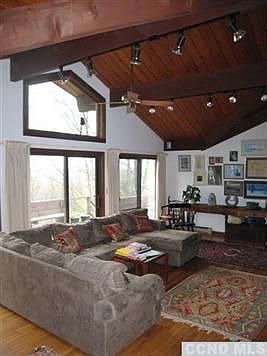 Vaulted beamed ceilings and hardwood floors of the open plan living room