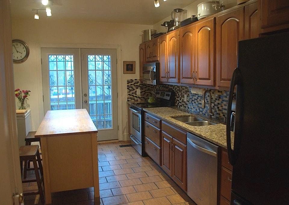 Kitchen with granite countertops, stainless steel appliances