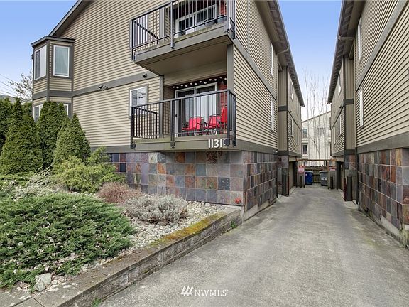 Ground level view of driveway to garages and access to building. Well cared for exteriors.