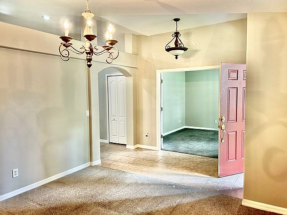 Looking from dining room to foyer and living room/den