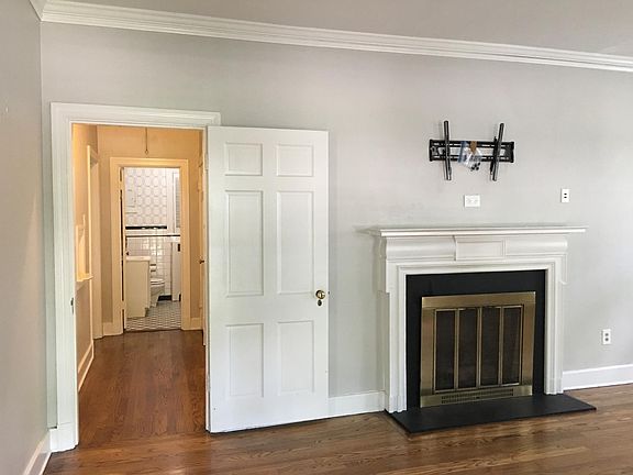Living room with tv mount installed above gas burning firepl