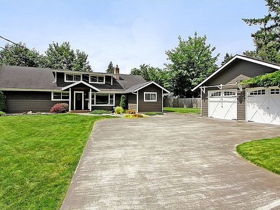 Lovely driveway leading to house and two car garage + shop. Light switch in house for exterior Holiday lighting. Landscape lighting in front on auto-timer from dusk to dawn.