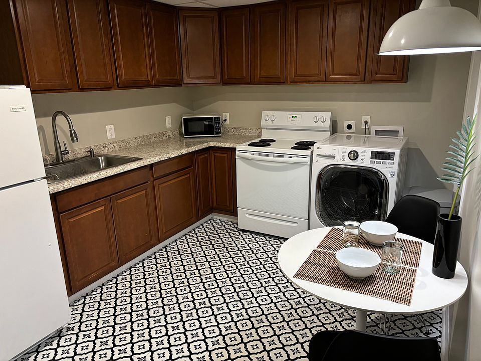 Kitchen area with washer/dryer combo unit, appliances, and kitchen-ware