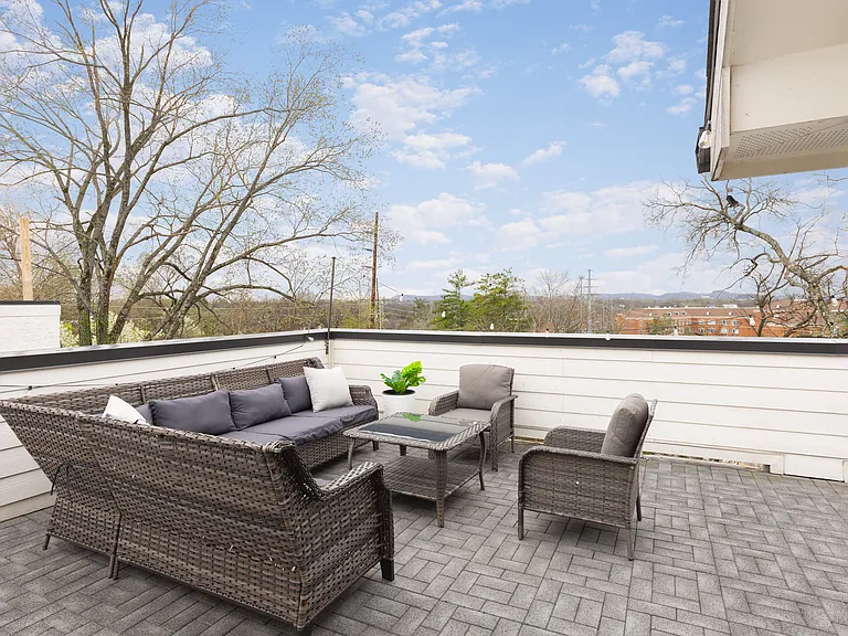 Private rooftop deck with plenty of seating and outdoor lights, allowing you to enjoy your morning cup of coffee or a late night conversation while overlooking the skyline.