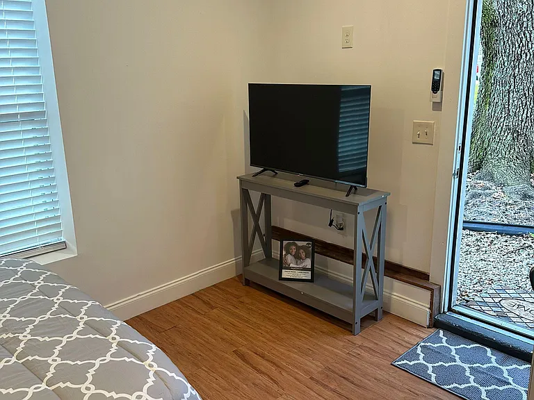The space includes a TV for entertainment, placed on a decorative table.