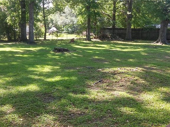 Large fenced back yard with lots of shade,