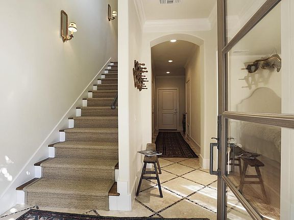 Notice this first floor stair case which has beautiful lighting and sisal carpet. The long hall lead