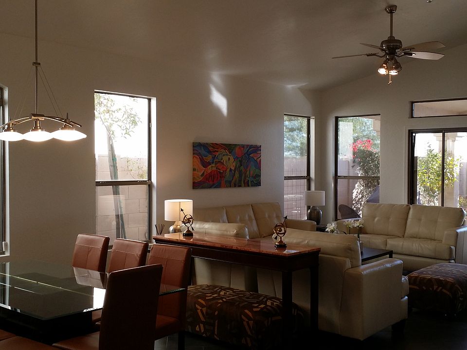 Living room with leather seating, 70"HDTV and den beyond.