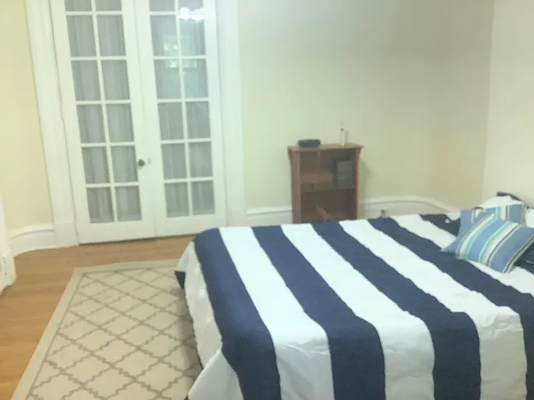 First bedroom showing closet with French doors. Curved walls and curved woodwork