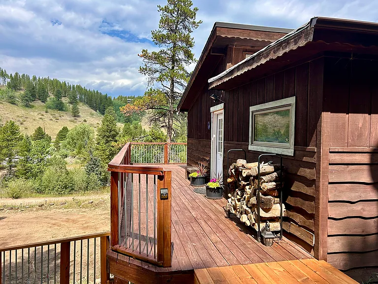 Sweeping private views from the wrap-around deck. Wood rack and wood included in rental.
