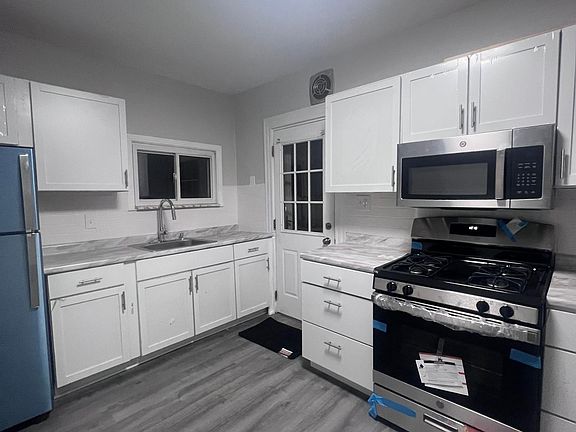 SS appliances and Shaker Cabinets & modern countertops
