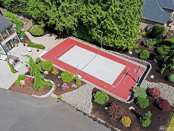 Lighted Sport Court Has A Built In Basketball Hoop And Tennis/Pickle Ball Net.