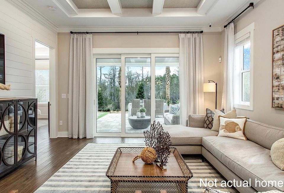 large living room overlooking lanai and private, wooded backyard