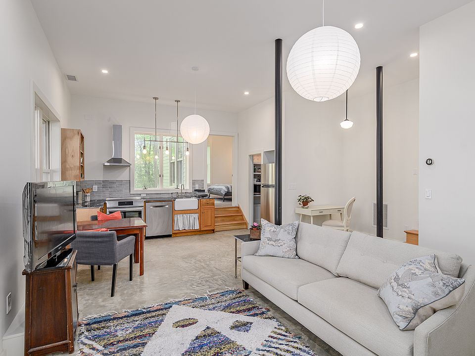 Loftlike open kitchen, dining area and living room with smart TV