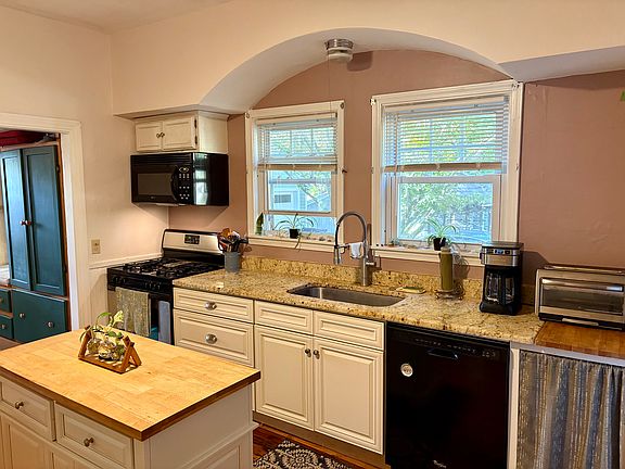 Granite countertops, Delta Faucet, new dishwasher, disposall, gas stove and bule in microwave; built in cutting board, island on wheels.