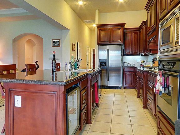 More features include wine cooler, built-in desk with glass cabinets above and under cabinet lighting.