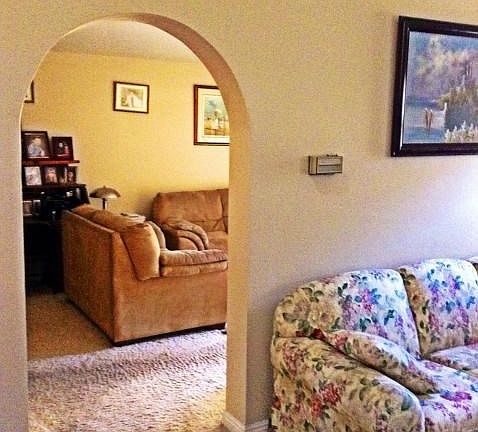 formal living room and archway to family room