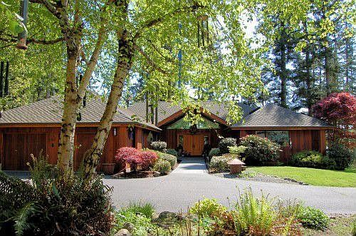 Go through the gated entry, then up a long winding driveway through lush grass and dappled woods. The setting of this home is truly special.
